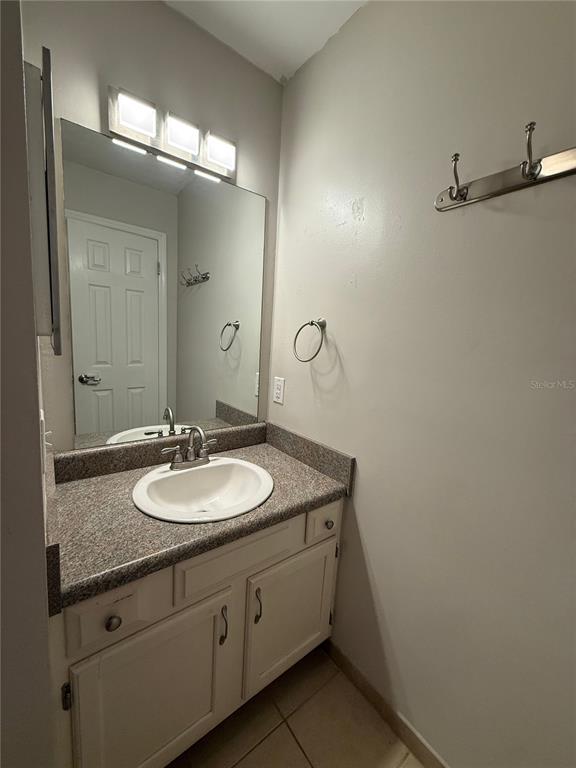 1515 Northwest 29 Road, Unit D2 Gainesville, FL 32605 - Photo 18 of 23 a bathroom with a granite countertop sink and a mirror