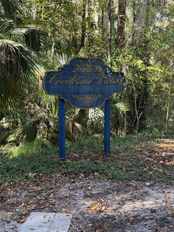 1515 Northwest 29 Road, Unit D2 Gainesville, FL 32605 - Photo 2 of 23 a view of a backyard with plants and large trees