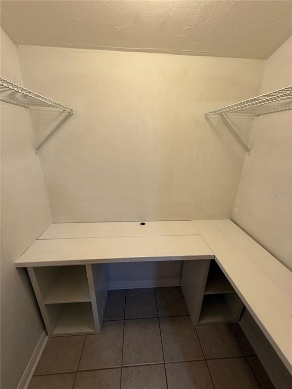 1515 Northwest 29 Road, Unit D2 Gainesville, FL 32605 - Photo 8 of 23 a room with a shelf and a cabinet