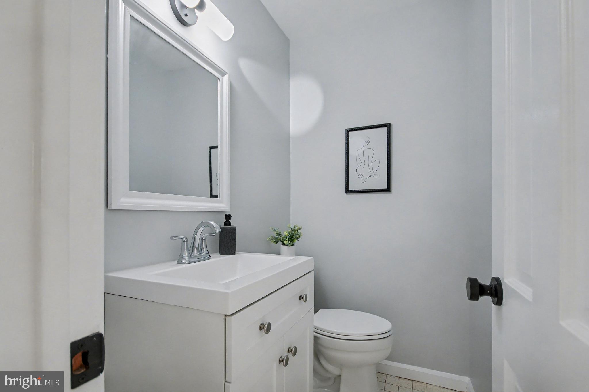 1729 Dana Street, Unit 6 Crofton, MD 21114 - Photo 17 of 33 a bathroom with a toilet sink and mirror