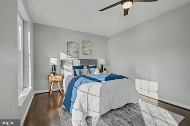 a bedroom with a bed and a painting on the wall