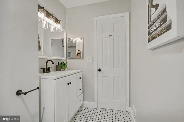 a bathroom with a sink a mirror and a shower