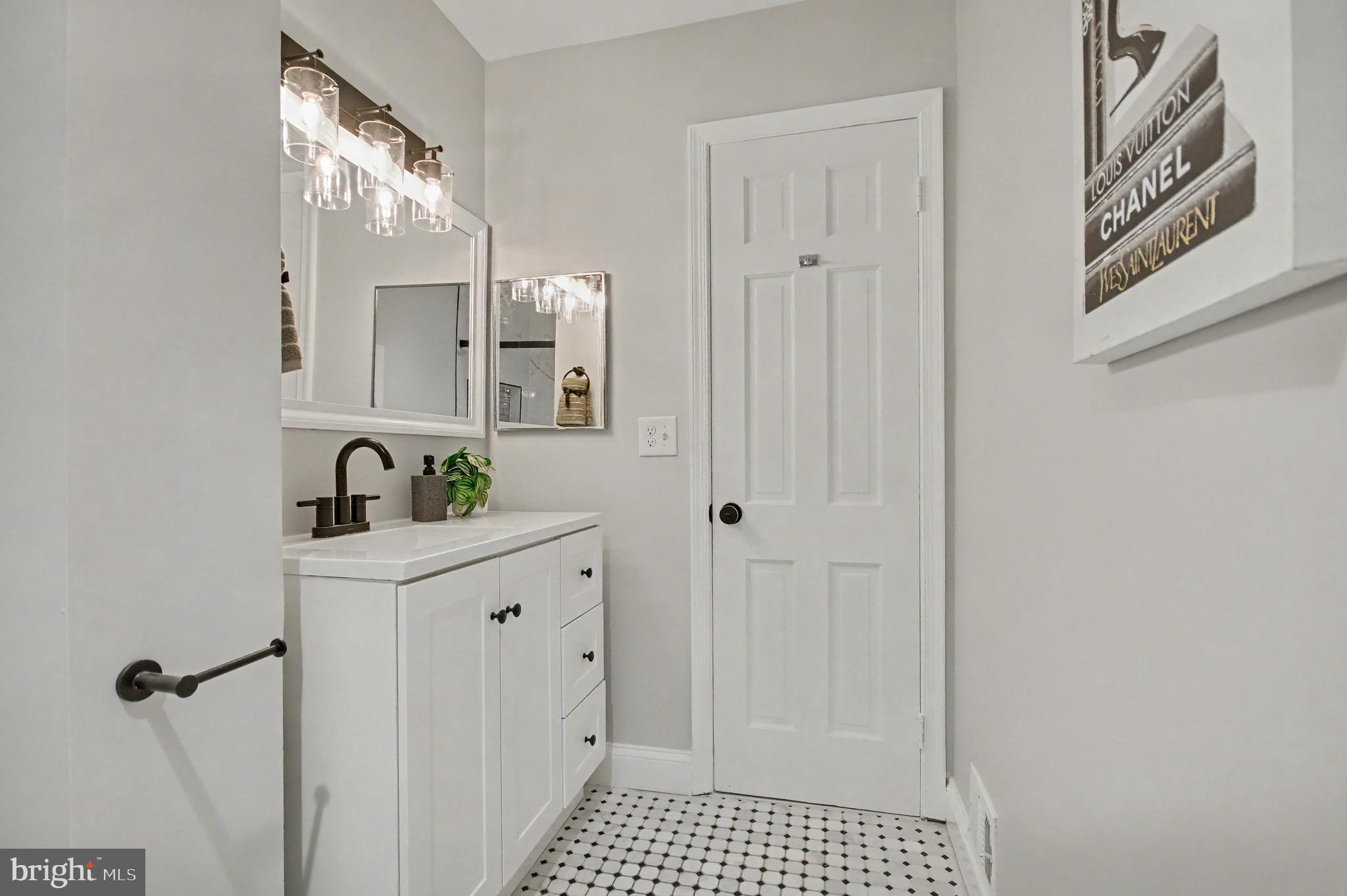 1729 Dana Street, Unit 6 Crofton, MD 21114 - Photo 23 of 33 a bathroom with a sink a mirror and a shower