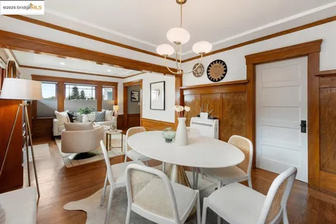 a view of a dining room with furniture a chandelier and wooden floor
