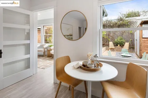 a dining room with furniture and a mirror