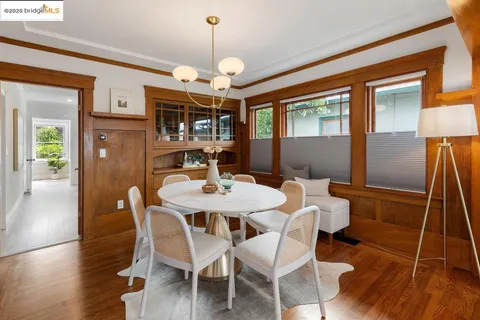 a view of a dining room with furniture wooden floor and chandelier