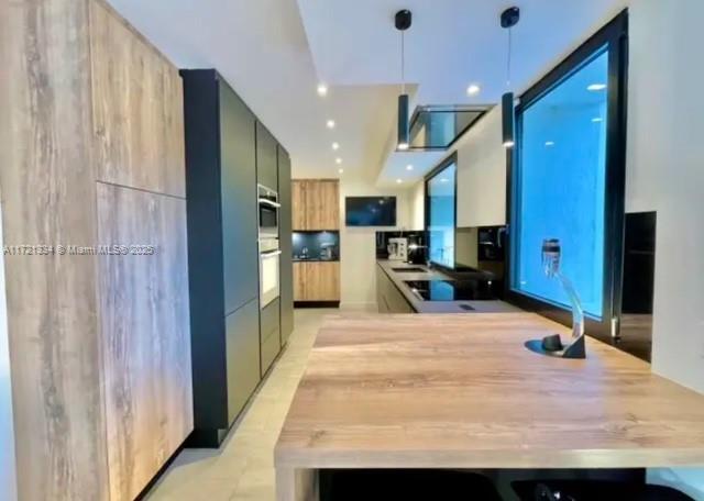 1 Rue Rolland Garros Aix Liverpool, England 13090 - Photo 13 of 31 a large white kitchen with a large window and stainless steel appliances