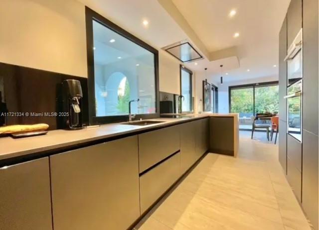 1 Rue Rolland Garros Aix Liverpool, England 13090 - Photo 15 of 31 a large kitchen with stainless steel appliances a large counter top a refrigerator a sink and a large window