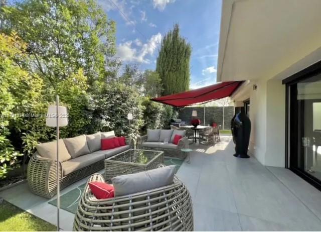 1 Rue Rolland Garros Aix Liverpool, England 13090 - Photo 18 of 31 a view of a patio with couches table and chairs under an umbrella with a fire pit