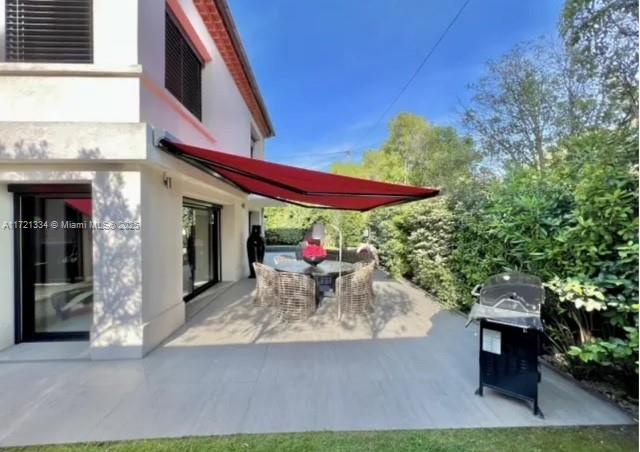 1 Rue Rolland Garros Aix Liverpool, England 13090 - Photo 24 of 31 a view of a patio with a table and chairs under an umbrella