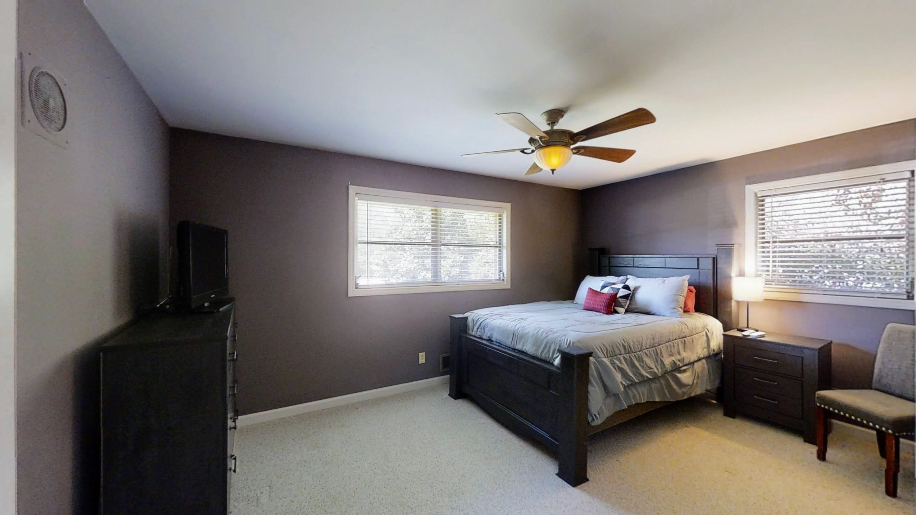 1115 Perry Road Zebulon, NC 27597 - Photo 13 of 37 a bedroom with a bed and a ceiling fan in it