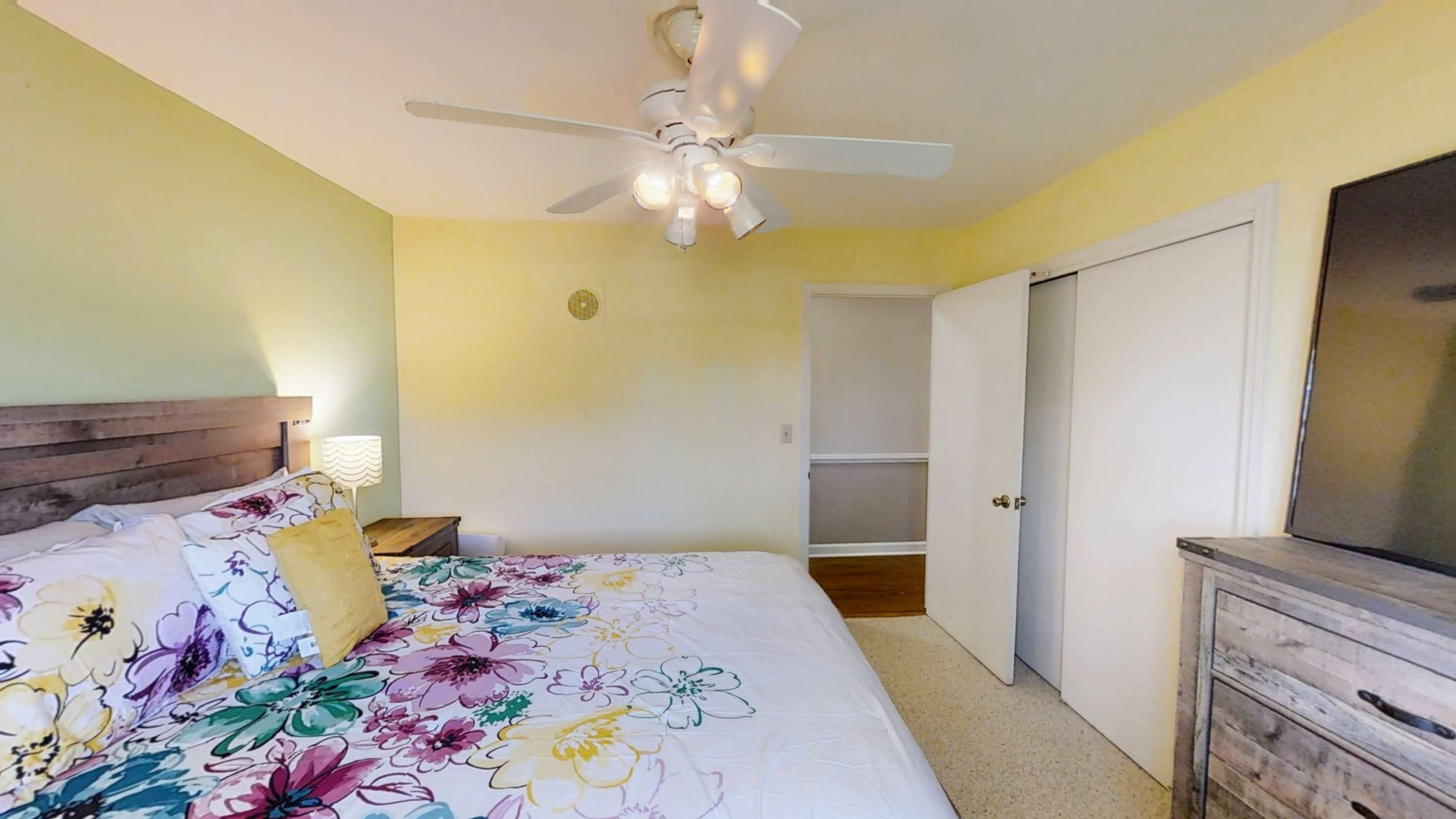 1115 Perry Road Zebulon, NC 27597 - Photo 15 of 37 a bedroom with a bed and a flat tv screen on the dresser