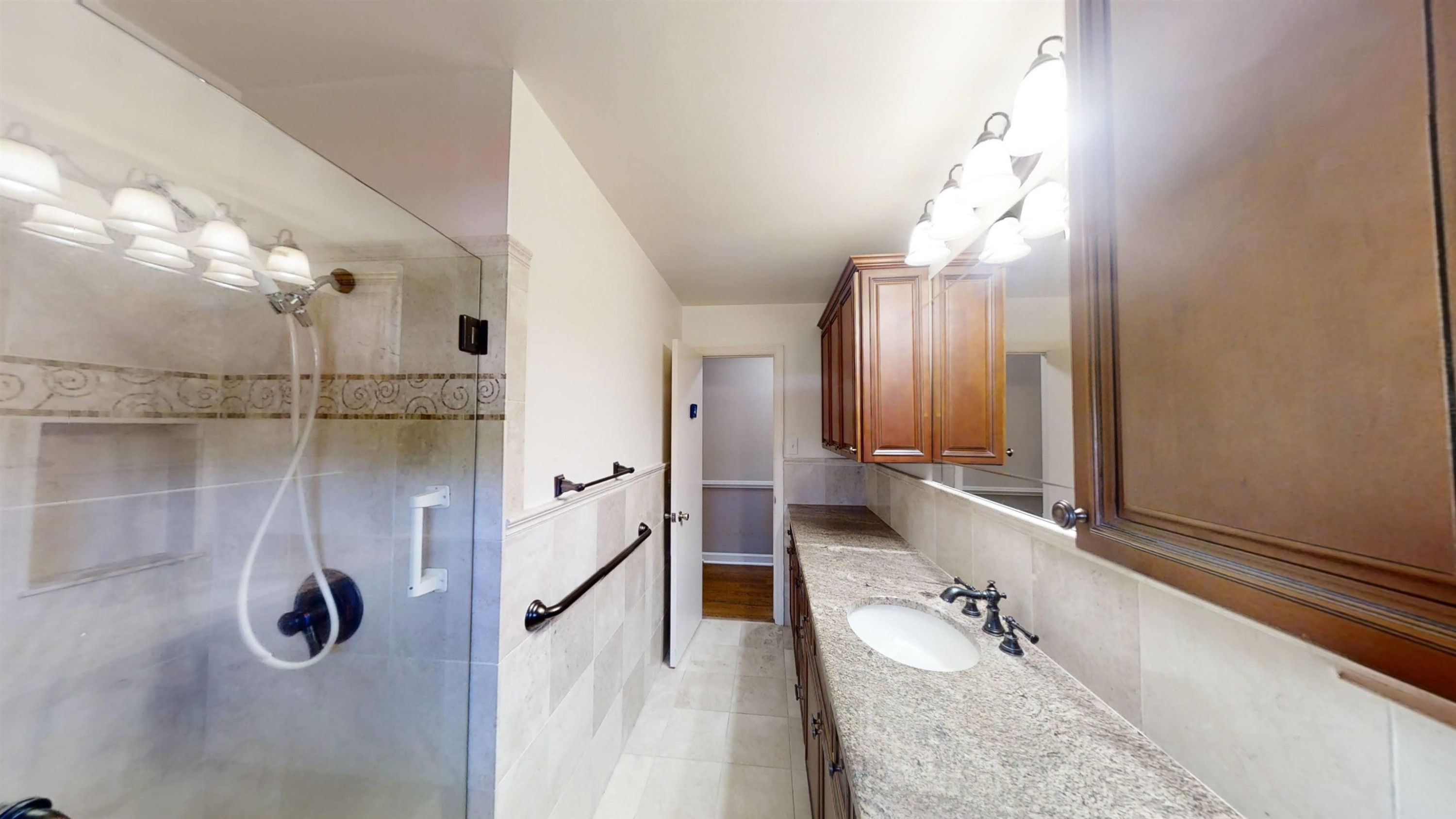 1115 Perry Road Zebulon, NC 27597 - Photo 19 of 37 a bathroom with a tub sink and mirror