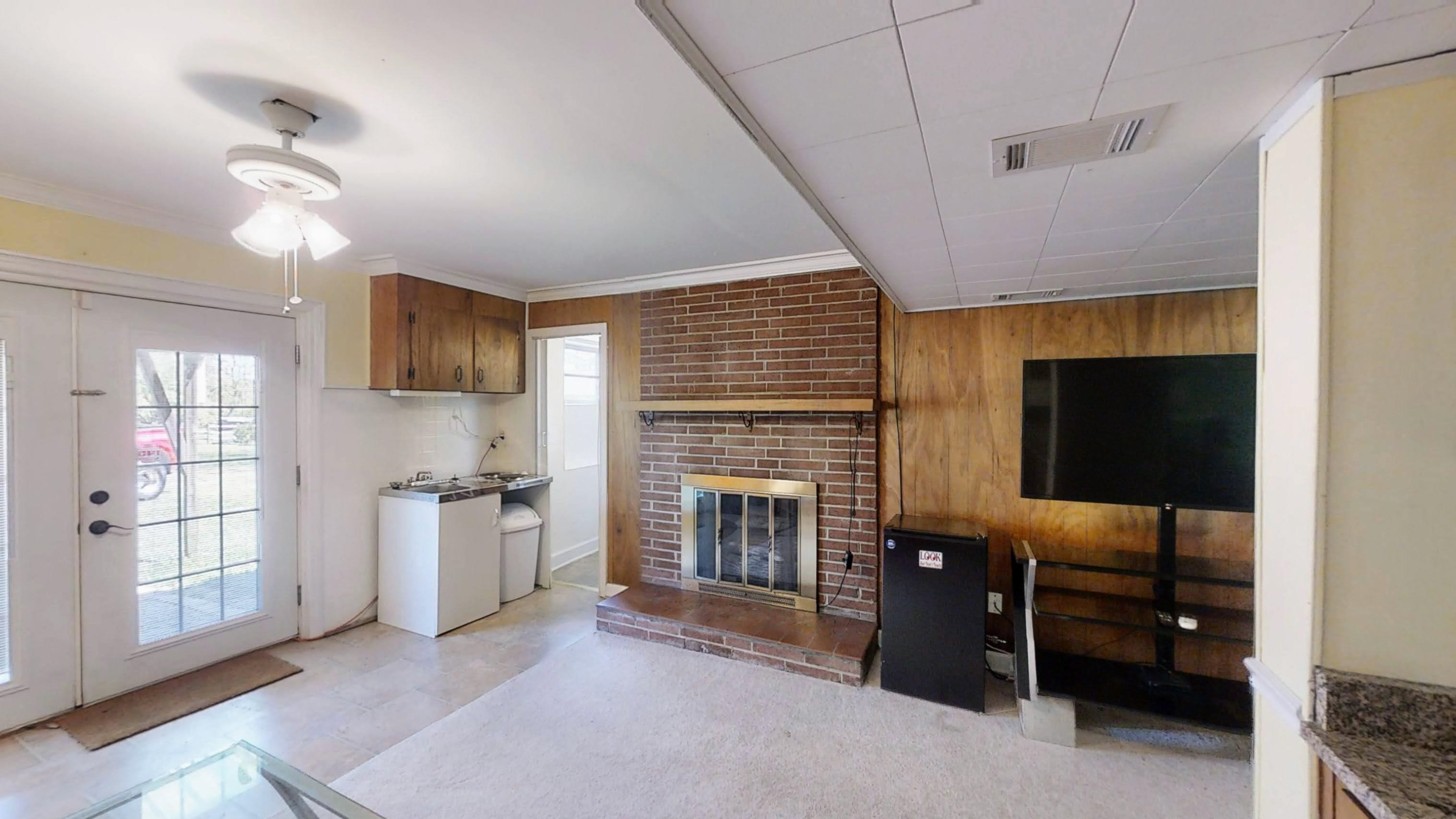 1115 Perry Road Zebulon, NC 27597 - Photo 25 of 37 a living room with furniture and a flat screen tv
