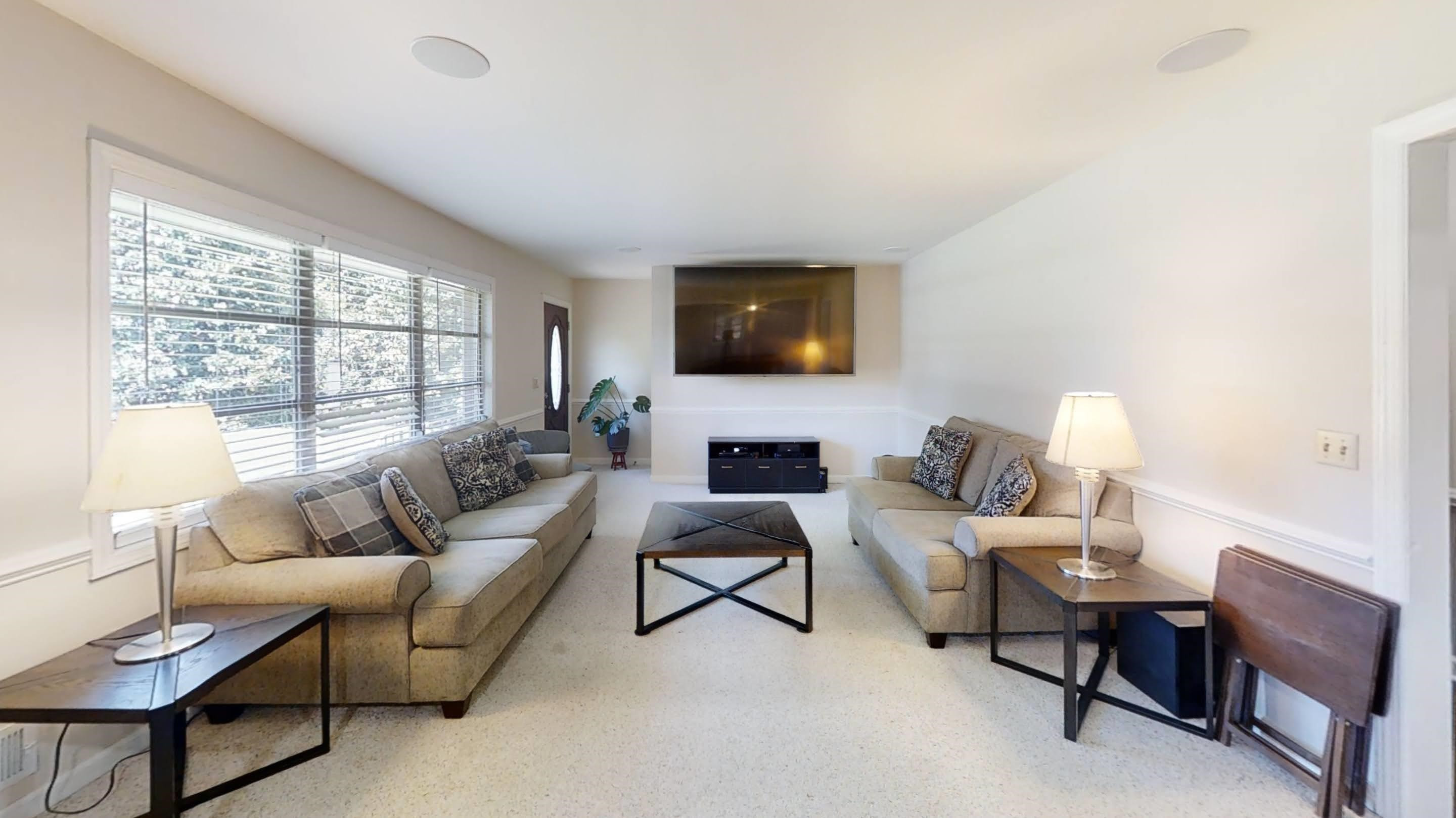 1115 Perry Road Zebulon, NC 27597 - Photo 36 of 37 a living room with furniture a fireplace and a flat screen tv
