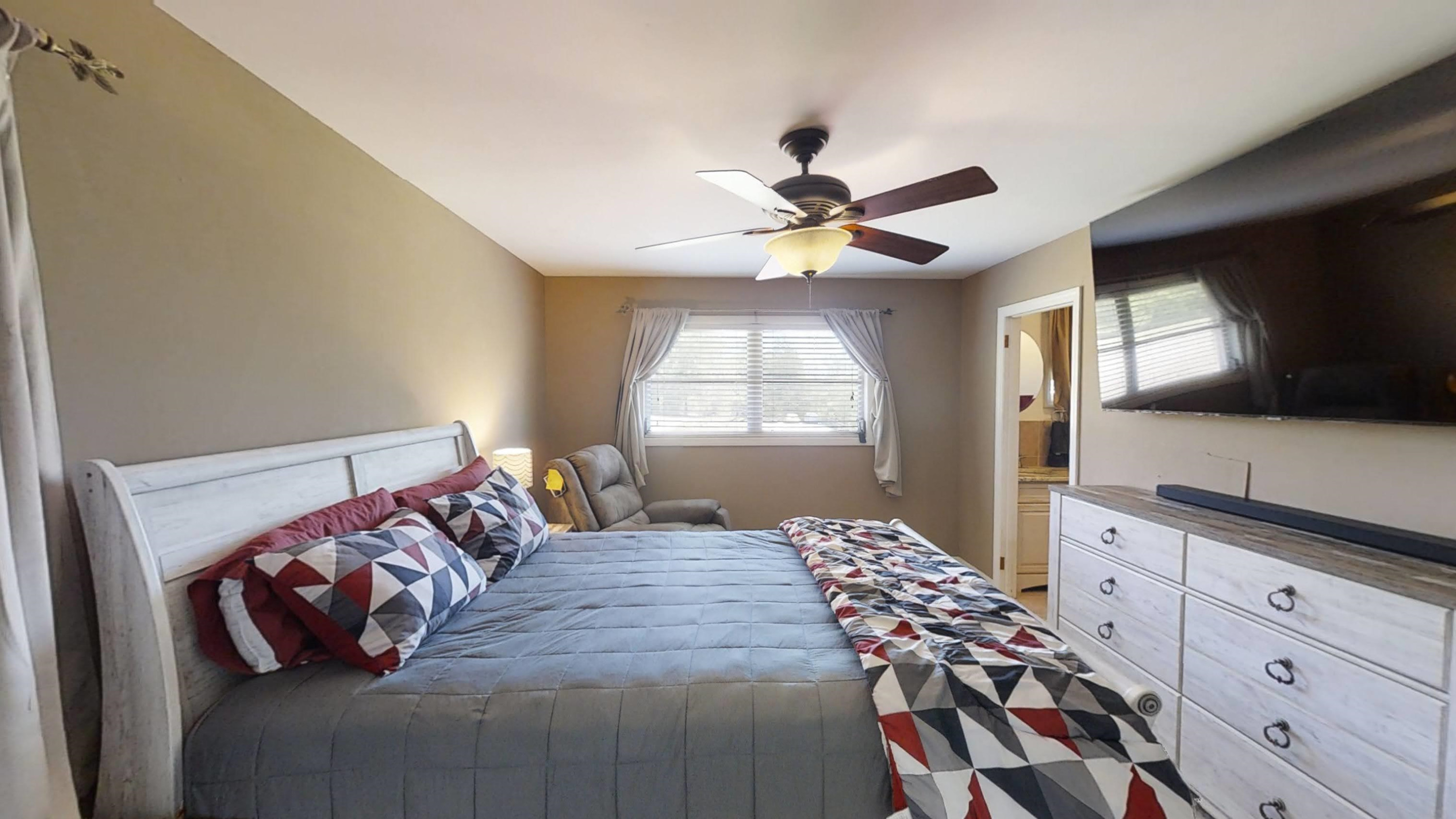 1115 Perry Road Zebulon, NC 27597 - Photo 9 of 37 a bedroom with a bed and a flat screen tv