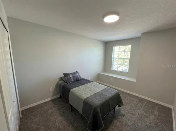 a bedroom with a bed and window