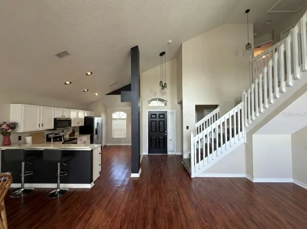 a view of a kitchen with cabinets and wooden floor