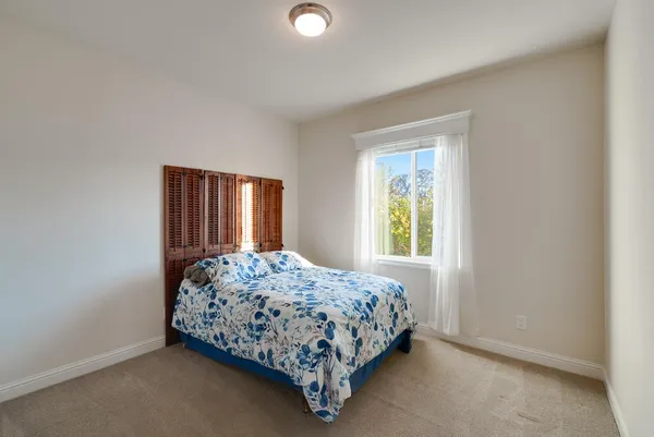 a bedroom with a bed lamp and window