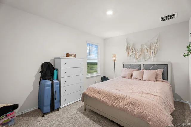 a bedroom with a bed and a dresser