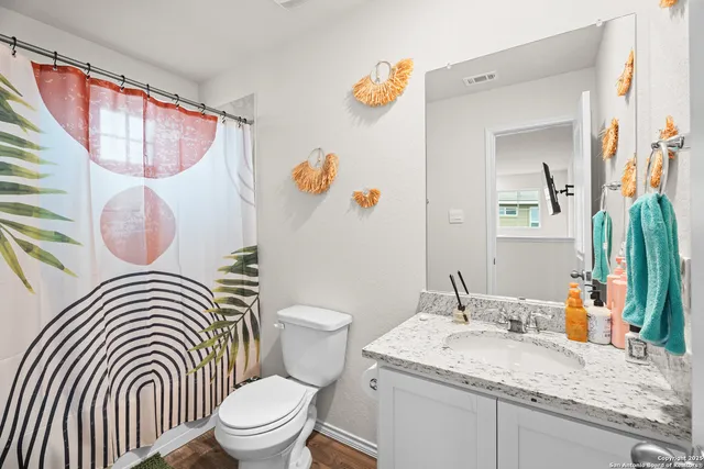 a bathroom with a sink a toilet and a mirror