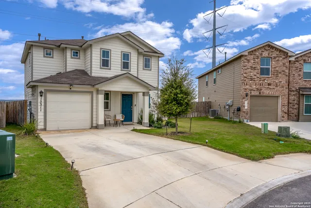 a front view of a house with a garden and plants