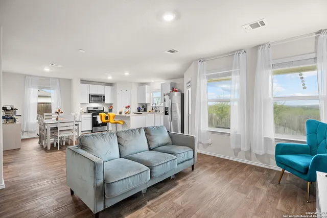 a living room with furniture and a large window