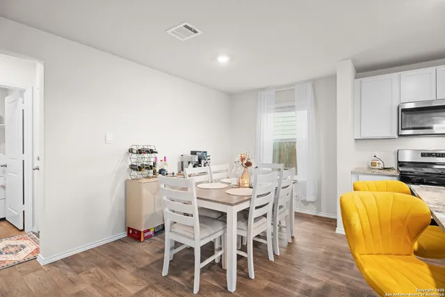 a view of a dining room with furniture and a kitchen