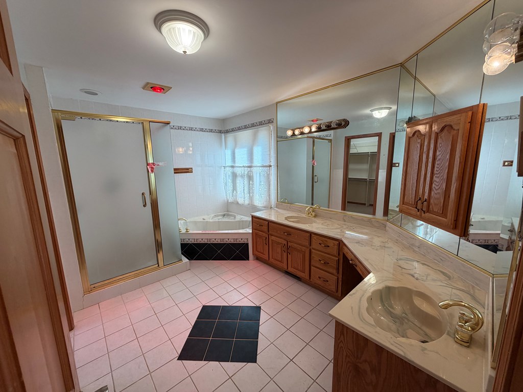 78 Timber Ridge Lane Hayesville, NC 28904 - Photo 13 of 43 a bathroom with double vanity sink a mirror a bathtub and shower