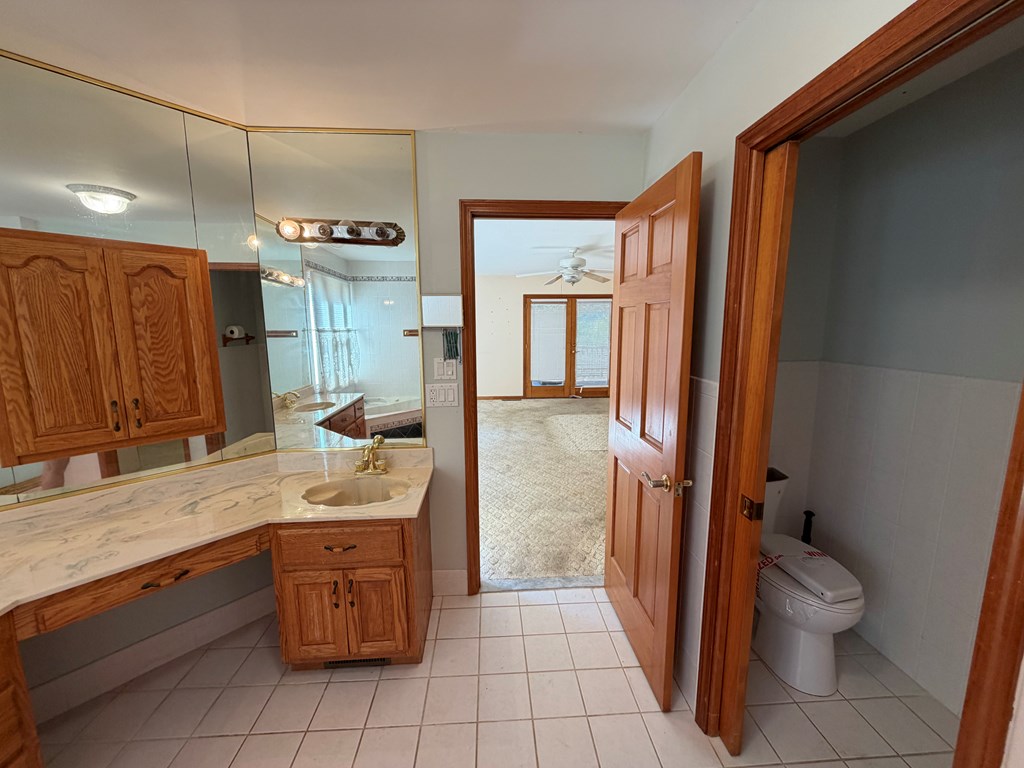 78 Timber Ridge Lane Hayesville, NC 28904 - Photo 14 of 43 a bathroom with a granite countertop sink toilet and shower