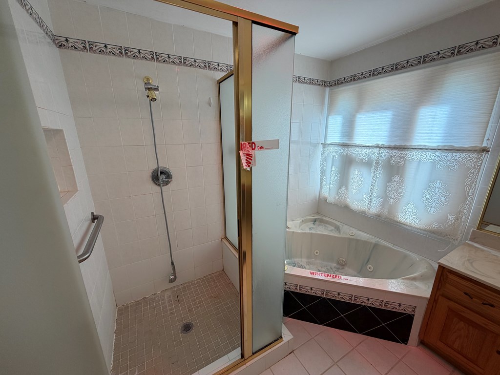 78 Timber Ridge Lane Hayesville, NC 28904 - Photo 16 of 43 a bathroom with a glass shower door
