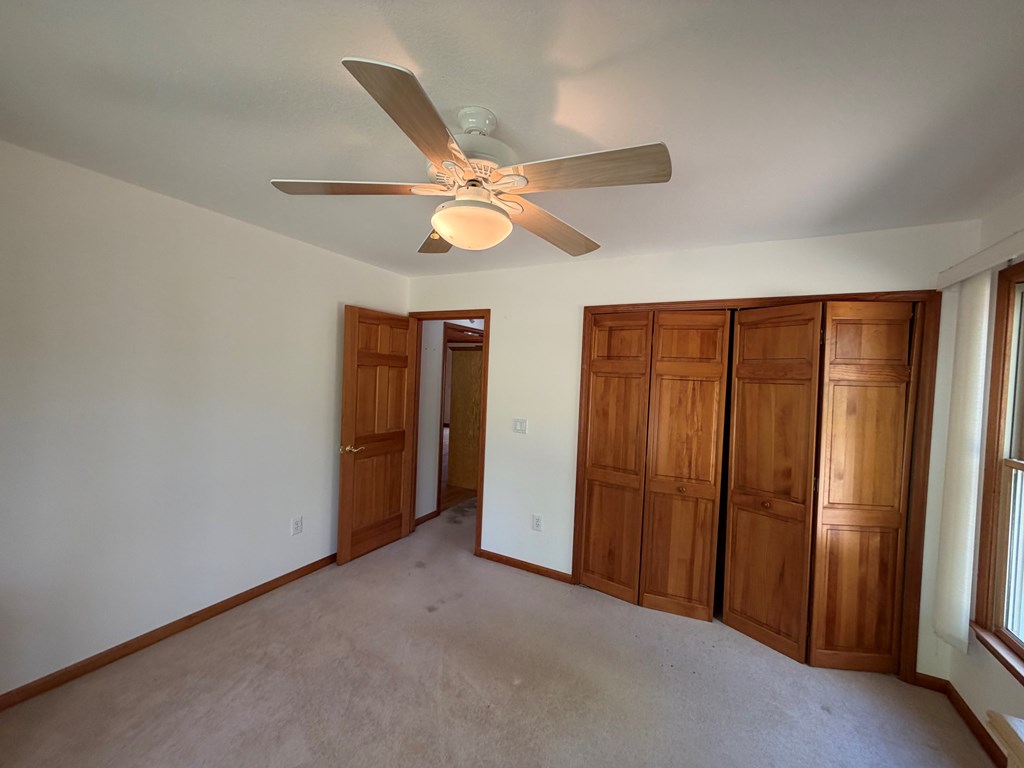 78 Timber Ridge Lane Hayesville, NC 28904 - Photo 17 of 43 an empty room with closet and a ceiling fan