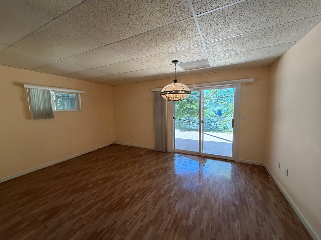78 Timber Ridge Lane Hayesville, NC 28904 - Photo 24 of 43 a view of an empty room with wooden floor and a window