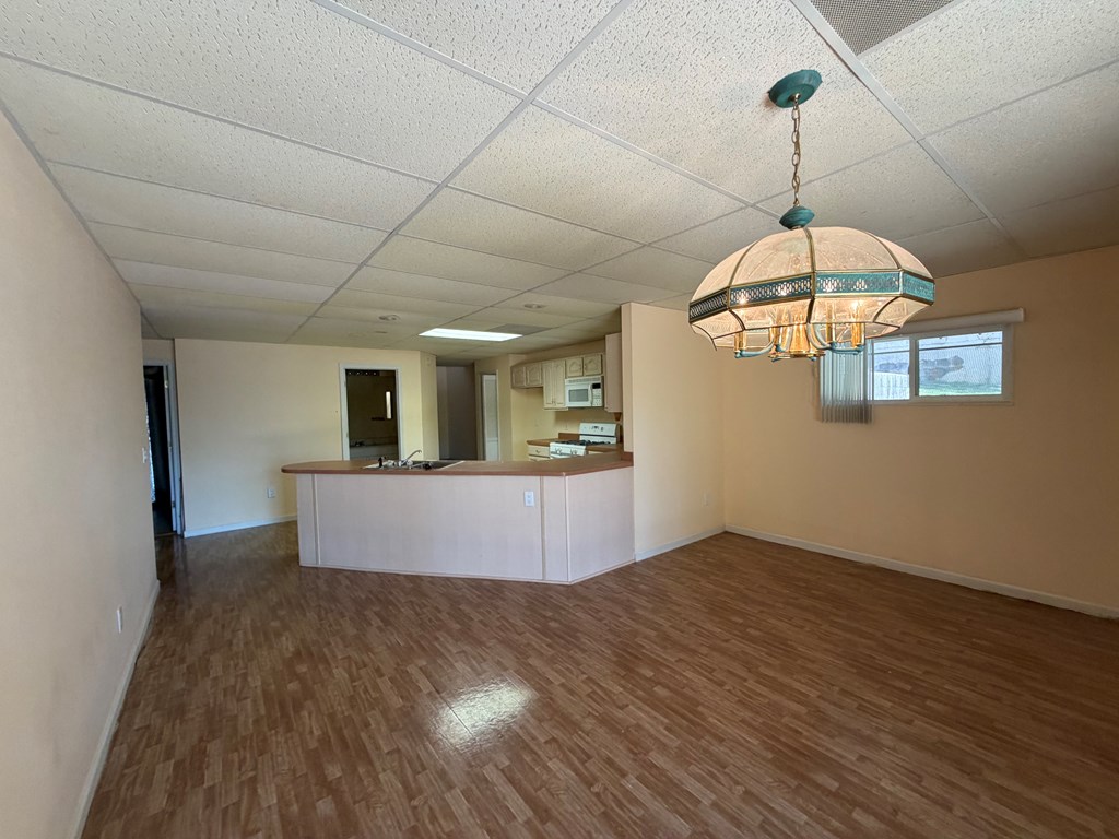 78 Timber Ridge Lane Hayesville, NC 28904 - Photo 28 of 43 a view of a room with wooden floor staircase and a chandelier