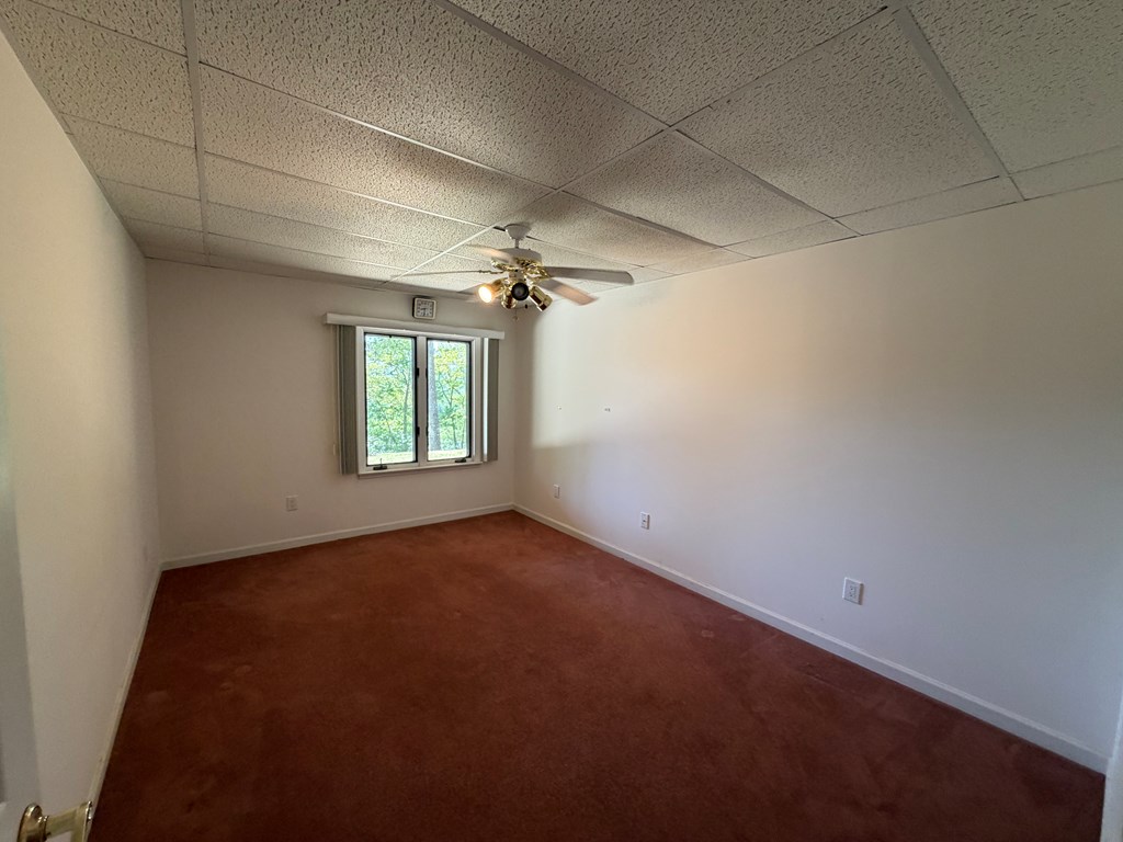 78 Timber Ridge Lane Hayesville, NC 28904 - Photo 29 of 43 an empty room with windows and chandelier fan