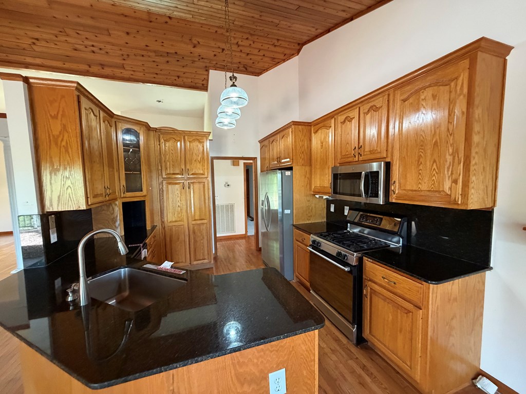 78 Timber Ridge Lane Hayesville, NC 28904 - Photo 7 of 43 a kitchen with stainless steel appliances granite countertop a sink a stove and a refrigerator