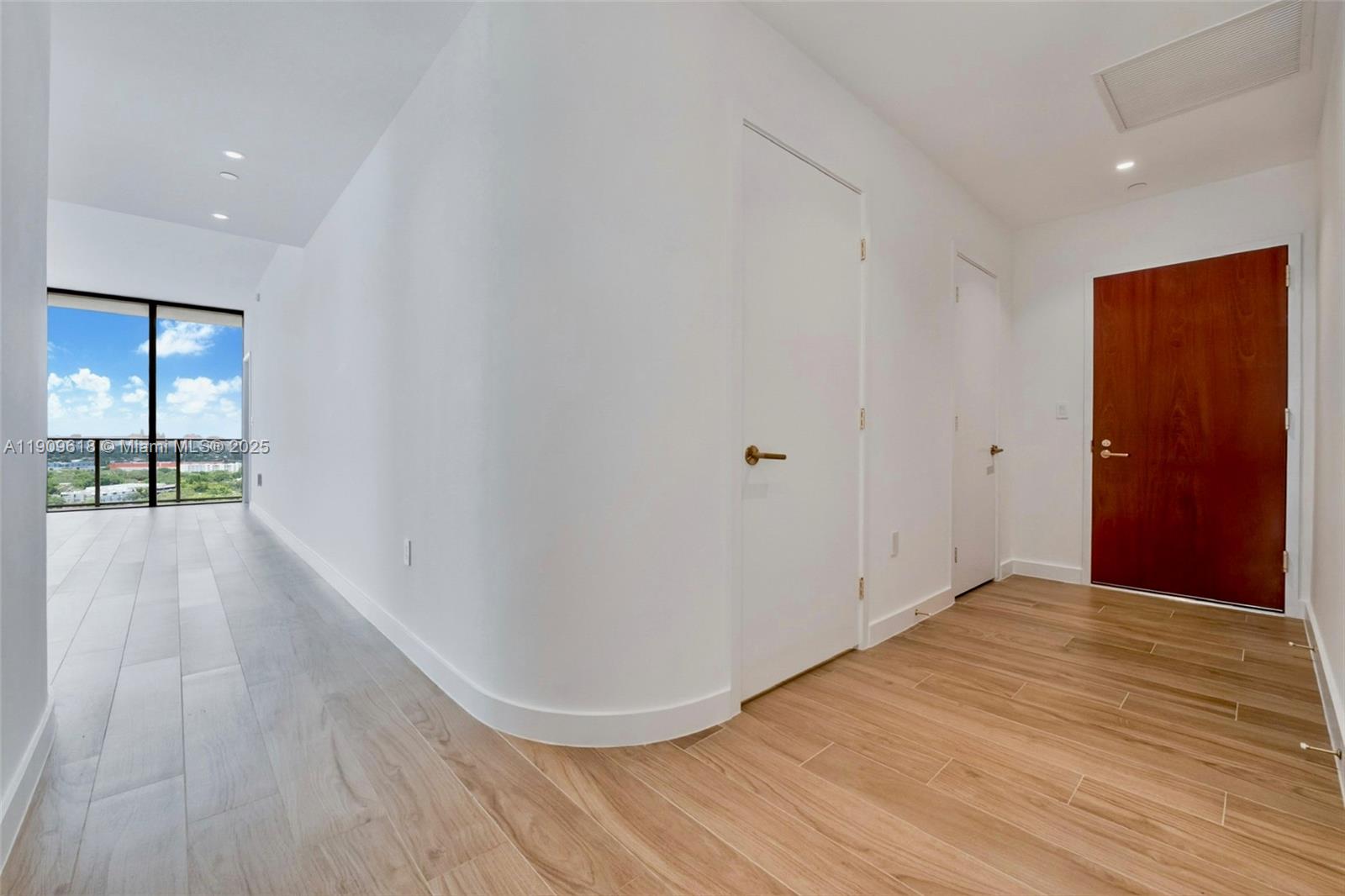 2678 Tigertail Avenue, Unit 1501 Miami, FL 33133 - Photo 14 of 44 wooden floor in an empty room with a window