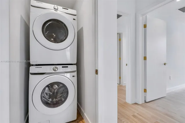 a view of a hallway with washer and dryer