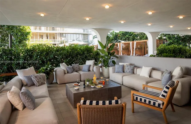 a living room with furniture and a potted plant