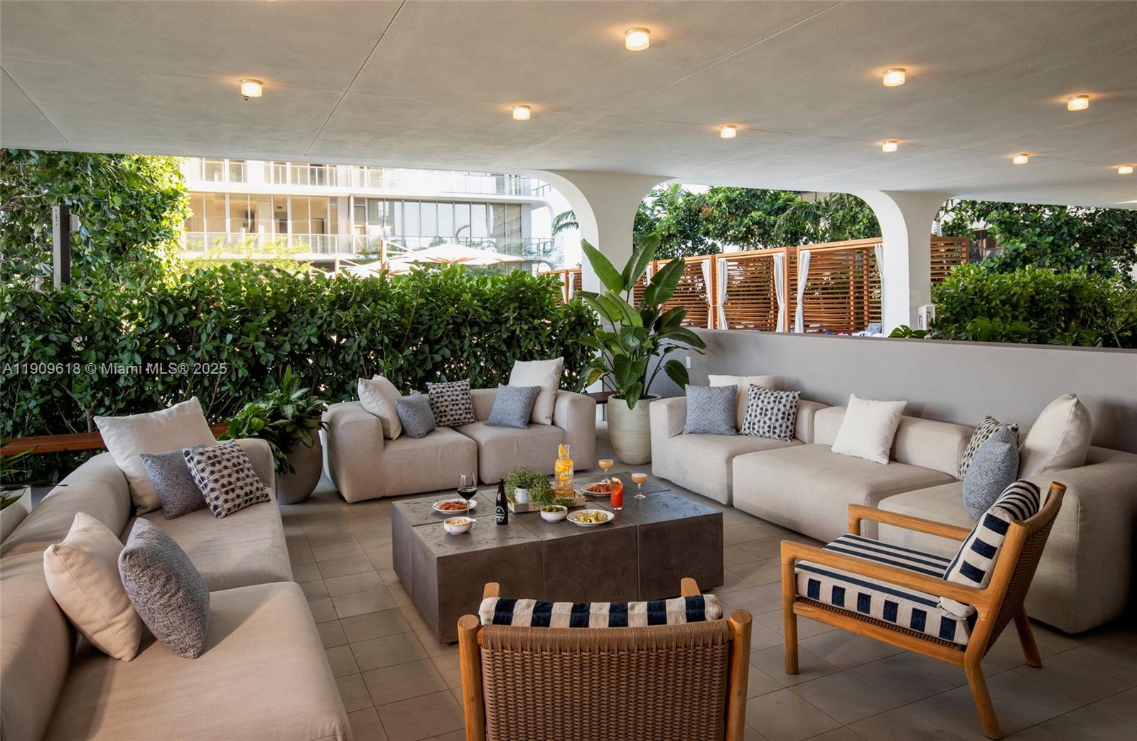 2678 Tigertail Avenue, Unit 1501 Miami, FL 33133 - Photo 31 of 44 a living room with furniture and a potted plant