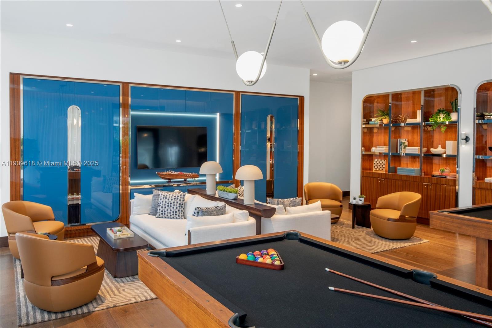 2678 Tigertail Avenue, Unit 1501 Miami, FL 33133 - Photo 32 of 44 a living room with furniture a chandelier and a large mirror