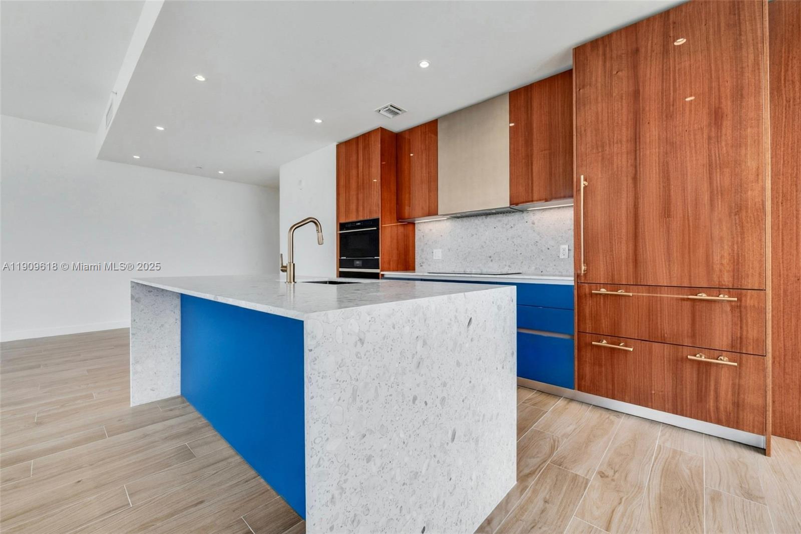 2678 Tigertail Avenue, Unit 1501 Miami, FL 33133 - Photo 5 of 44 a kitchen with stainless steel appliances granite countertop a refrigerator a sink and a stove