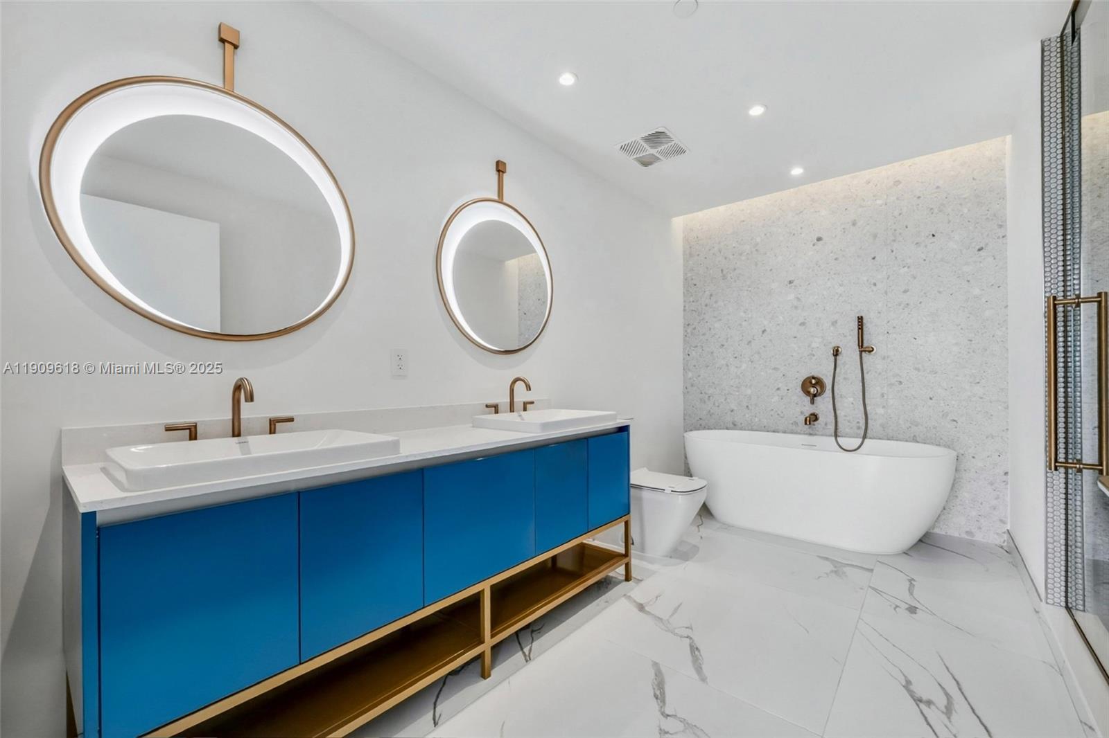 2678 Tigertail Avenue, Unit 1501 Miami, FL 33133 - Photo 6 of 44 a bathroom with a toilet a double vanity sink and a mirror