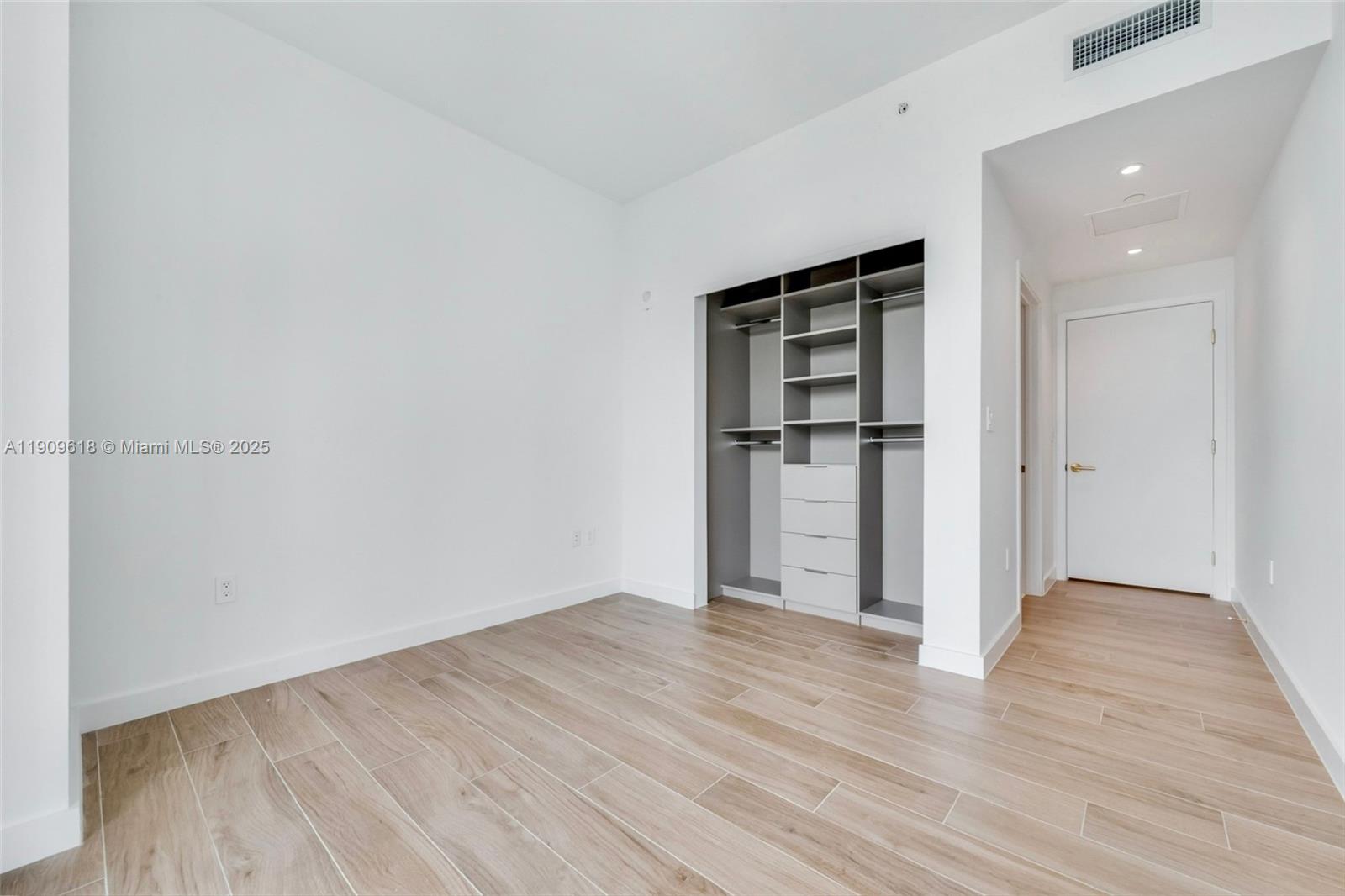 2678 Tigertail Avenue, Unit 1501 Miami, FL 33133 - Photo 9 of 44 wooden floor in an empty room with wooden floor