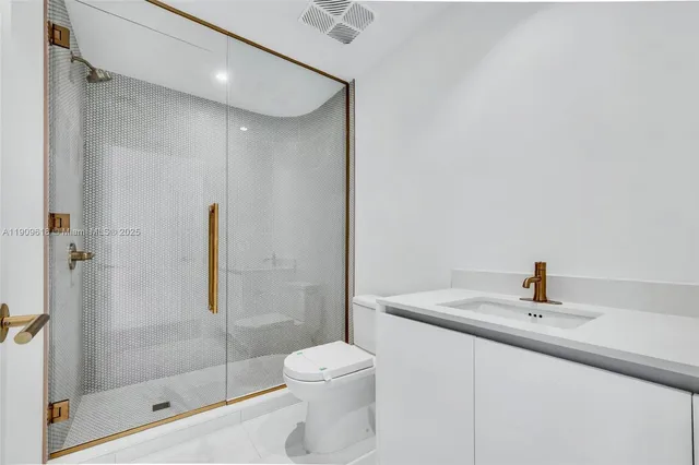 a bathroom with a sink toilet and shower