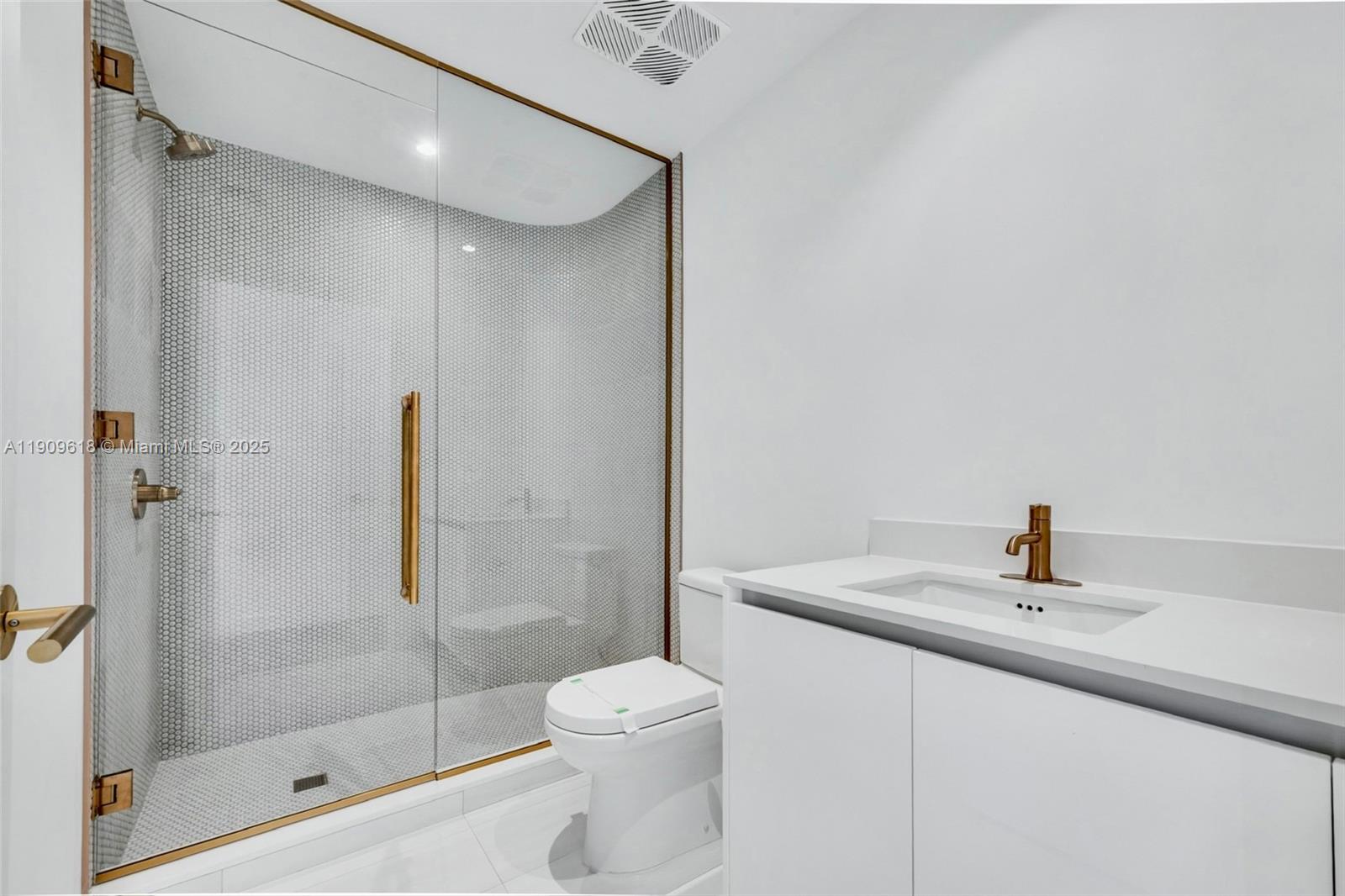 2678 Tigertail Avenue, Unit 1501 Miami, FL 33133 - Photo 10 of 44 a bathroom with a sink toilet and shower