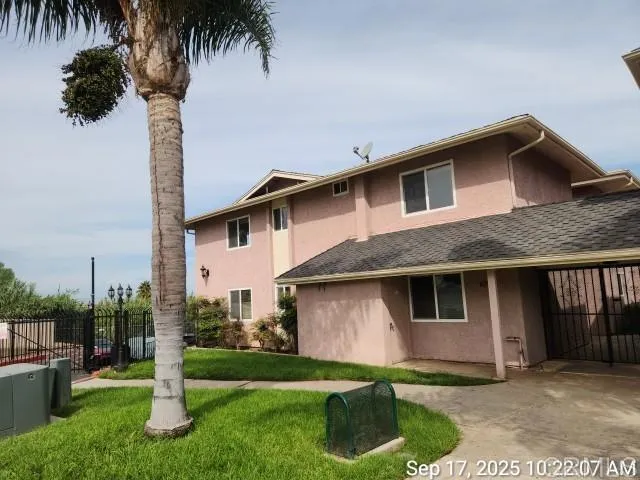 a front view of a house with a garden and yard