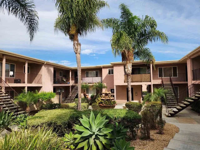 a front view of a house with garden and patio
