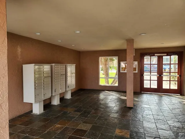 a view of an empty room with a fireplace and a window
