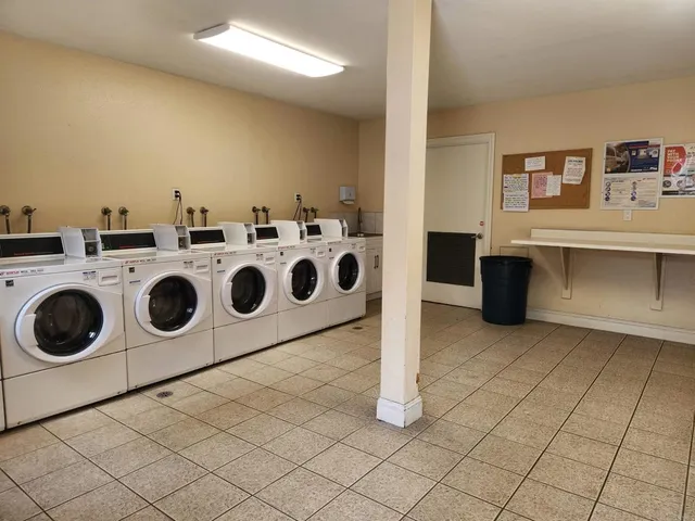 a utility room with stainless steel appliances washer and dryer